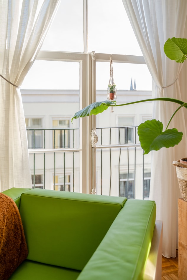 Chair in front of window with custom drapes for interior design